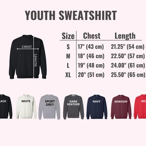 May include: A black youth sweatshirt with size and color options. The image includes a size chart with chest and length measurements in inches and centimeters. Available colors are black, white, sport grey, dark heather, navy, maroon, and red.