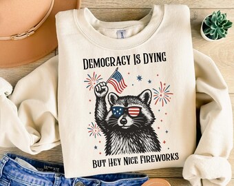 Democracy Is Dying Fourth of July Protest Sweatshirt, But Hey Nice Fireworks Sweatshirt, Funny Political Racoon Sweatshirt,Retro USA Graphic