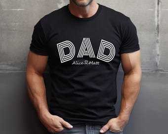 May include: Black t-shirt with a white graphic of the word "DAD" in a retro style. The text "Alice & Matt" is printed below the word "DAD".