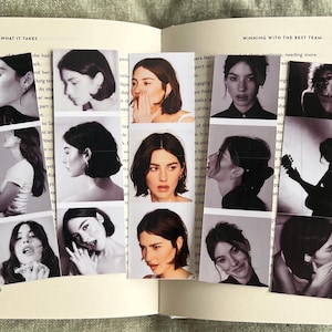 May include: A collage of black and white photos of a woman with short hair. The photos are arranged in a grid pattern on a book with the text "What It Takes" and "Winning With The Best Team" visible.