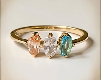 Anillo marquesa de tres piedras, oro pasado, presente y futuro, trilogía de piedras preciosas en tonos pastel.