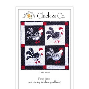 May include: A 21" x 21" wall quilt featuring four squares with rooster designs. Each rooster has a red comb and wattle, with black and white patterned feathers. The quilt has a black and white polka dot and solid background with red accents. Text reads "Cluck & Co."