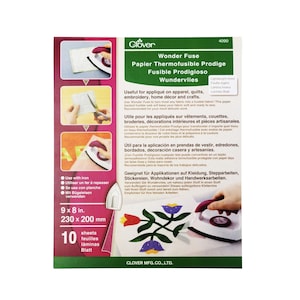 May include: A pack of 10 sheets of Wonder Fuse fusible web for crafts. The pack is green and white with an image of an iron and a colorful quilt. The text on the pack reads "Wonder Fuse Papier Thermofusible Prodige Fusible Prodigioso Wundervlies".