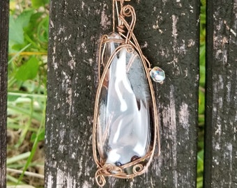 Long necklace with wrapped glass pendant