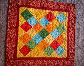 Little quilt in bright red, yellow, orange - table topper, wall hanging, or accent piece