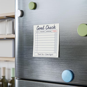 May include: A rectangular magnet with the words "Goal Check" printed in black script. The magnet has a checklist design with the text "DATE", "PERSONS", and "SERVER NO. 75901". The phrase "Thank You - Come Again" is at the bottom.