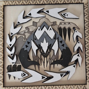 May include: A wooden wall plaque with a black and white design of a monster with sharp teeth and claws. The monster is surrounded by a circle of white and black arrows.