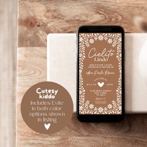 May include: A smartphone displays a baby shower invitation with the text "Cielito Lindo" in white script. The invitation is on a brown background with floral accents. A circular graphic states "Includes Evite in both color options shown in listing."
