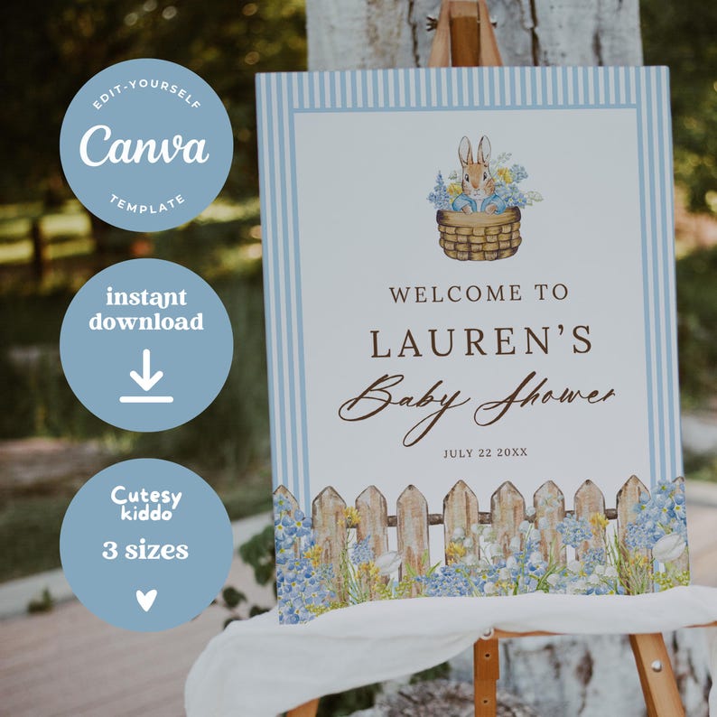 May include: A baby shower sign with a blue and white striped border. The sign reads "Welcome to Lauren's Baby Shower" with the date July 22 20XX. A bunny in a basket of flowers is at the top.