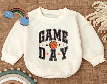 May include: A cream-colored sweatshirt with a graphic print of a basketball and the text "GAME DAY" in black.