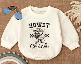 May include: A cream colored baby onesie with a black and white graphic of a cartoon chicken wearing a cowboy hat and sunglasses. The text "Howdy Chick" is printed below the graphic.