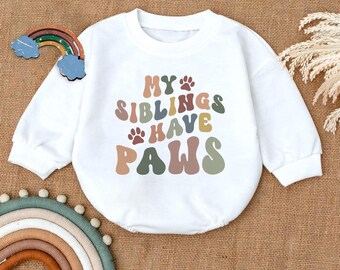 May include: White long-sleeved baby onesie with a colorful graphic that reads "My siblings have paws".