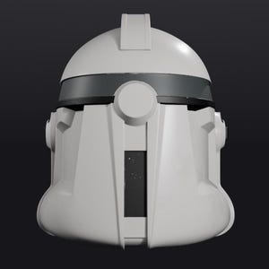 Pode incluir: Um capacete branco e cinza com uma viseira escura. O capacete tem um topo arredondado com um detalhe retangular e detalhes circulares nas laterais. O design &eacute; sim&eacute;trico e futurista, sobre um fundo escuro.