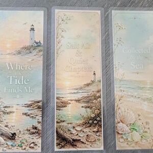 May include: Three rectangular bookmarks featuring coastal scenes with lighthouses, sandy shores, and seashells. The text reads Where the Tide Finds Me, Salt Air & Quiet Chapters, and Collected by the Sea, set against soft pastel sunset and ocean backgrounds.