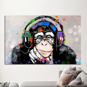 May include: A colorful abstract painting of a monkey wearing headphones. The monkey is sitting with its chin on its hand and has a relaxed expression. The background is a light gray with splashes of color.