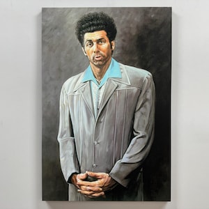 May include: A painting of a person with dark brown hair wearing a light gray suit jacket over a light blue shirt. The person is standing with their hands clasped in front of them.