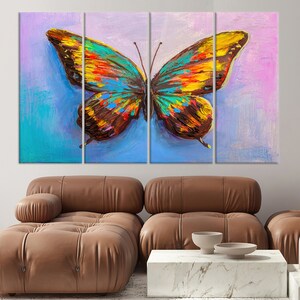 May include: A vibrant, multi-panel canvas art piece featuring a colorful butterfly. The butterfly's wings display a mix of blue, yellow, orange, and brown hues against a backdrop of blue and pink. The artwork is displayed above a brown leather sofa.