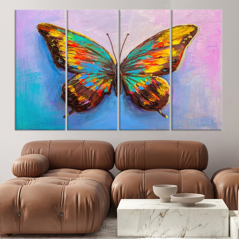 May include: A vibrant, multi-panel canvas art piece featuring a colorful butterfly. The butterfly's wings display a mix of blue, yellow, orange, and brown hues against a backdrop of blue and pink. The artwork is displayed above a brown leather sofa.