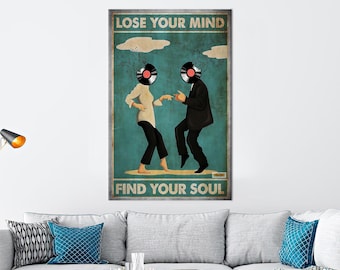 May include: A vintage-style poster with a blue background featuring a man and woman dancing. The man and woman have vinyl records for heads. The poster reads "Lose Your Mind Find Your Soul".