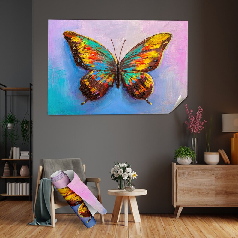 May include: A large, colorful butterfly painting with a blue, purple, and yellow background. The butterfly has detailed wings with shades of brown, yellow, orange, and blue. A rolled-up canvas with a similar butterfly design is in the foreground.