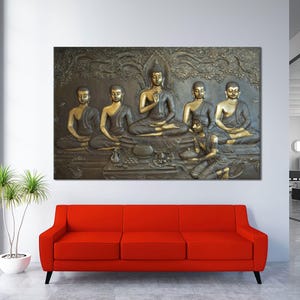 May include: A wall art print featuring a relief sculpture of seven golden Buddha figures seated in a row. The figures are surrounded by intricate carvings and floral motifs.