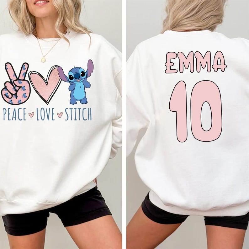 May include: White sweatshirt with a peace sign, heart, and Stitch character on the front. The back of the sweatshirt has the name "Emma" and the number "10" in pink.