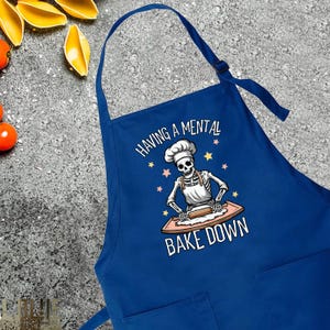 a blue apron with a skeleton on it