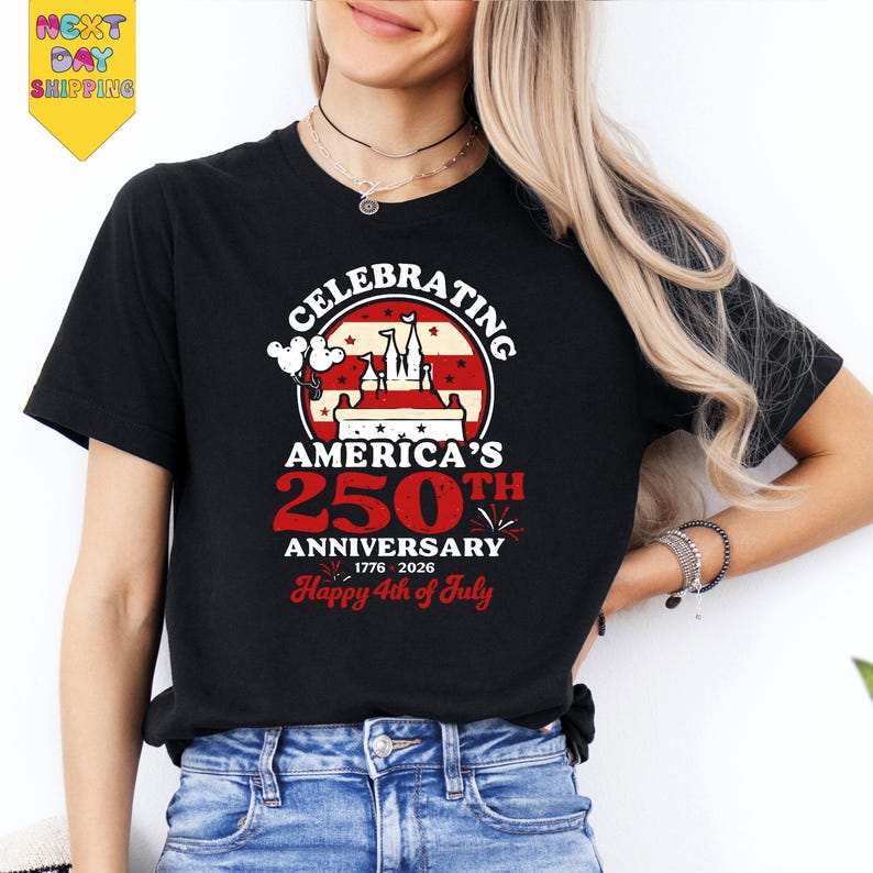 A woman wearing a black t-shirt with a graphic design celebrating the 250th anniversary of Disney's Mickey Mouse.