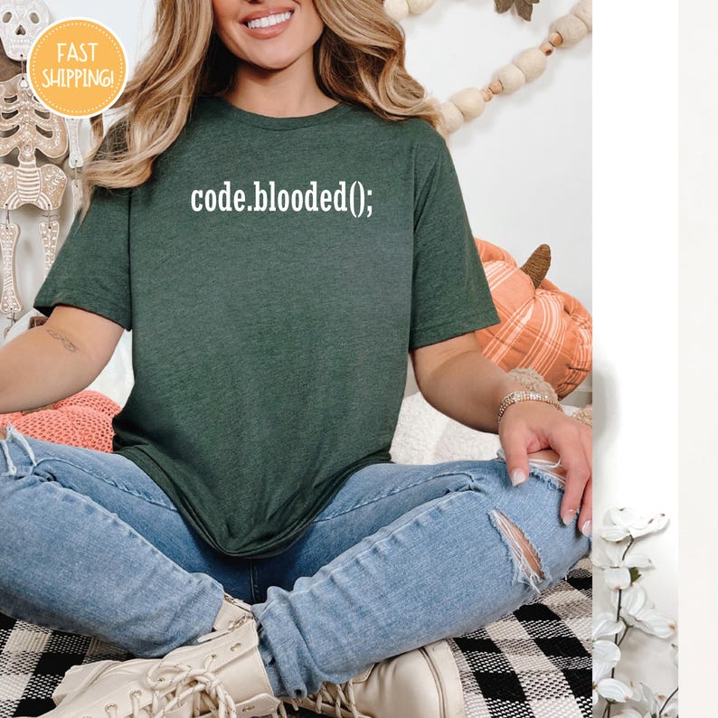a woman in a green shirt is sitting on a checkered blanket