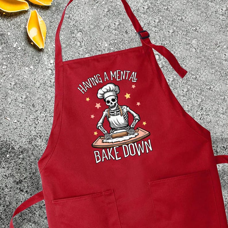 a red apron that says having a mental bake down