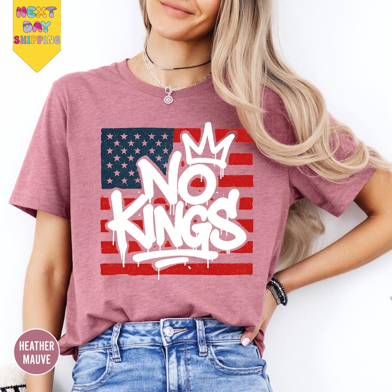 a woman wearing a pink shirt with the words no kings on it