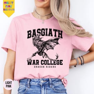 a woman wearing a pink shirt with a dragon on it