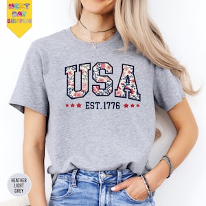 a woman wearing a usa t - shirt and jeans