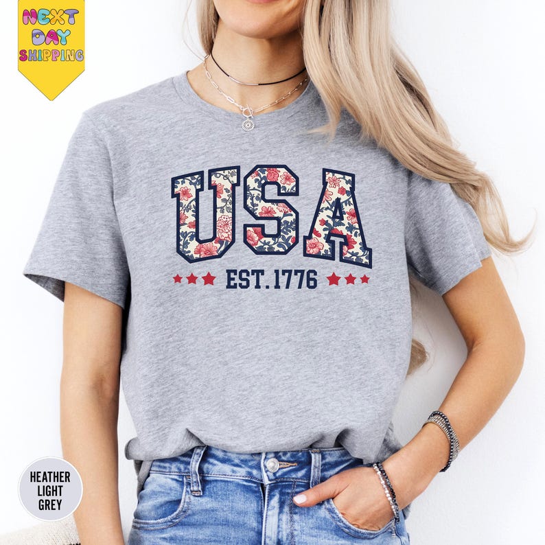 a woman wearing a usa t - shirt and jeans