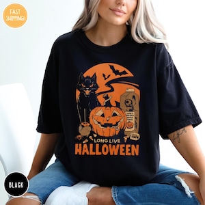 a woman wearing a black long live halloween t - shirt