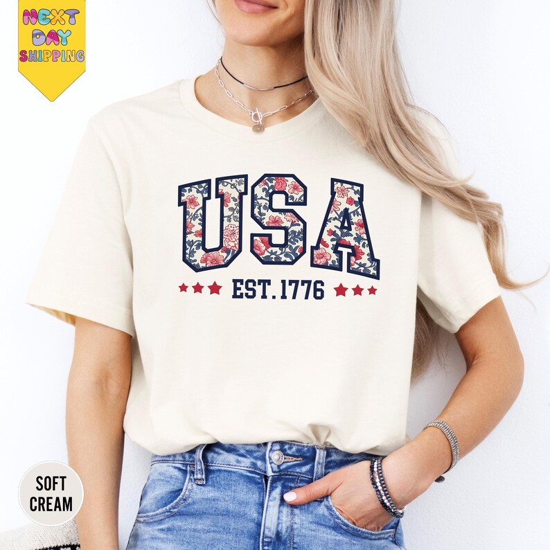 a woman wearing a usa t - shirt and jeans