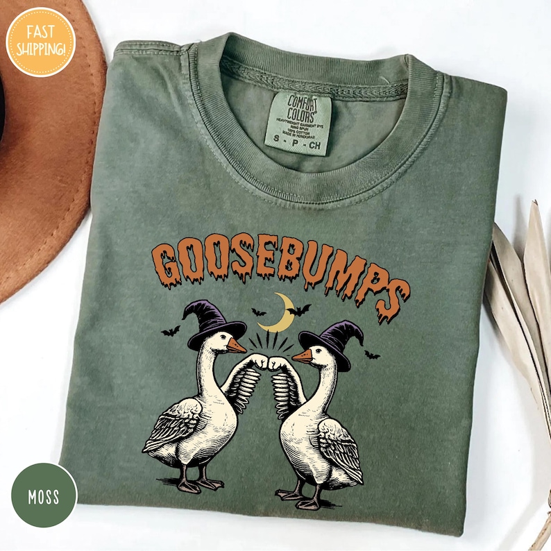 goose bumps t - shirt on a table next to a hat