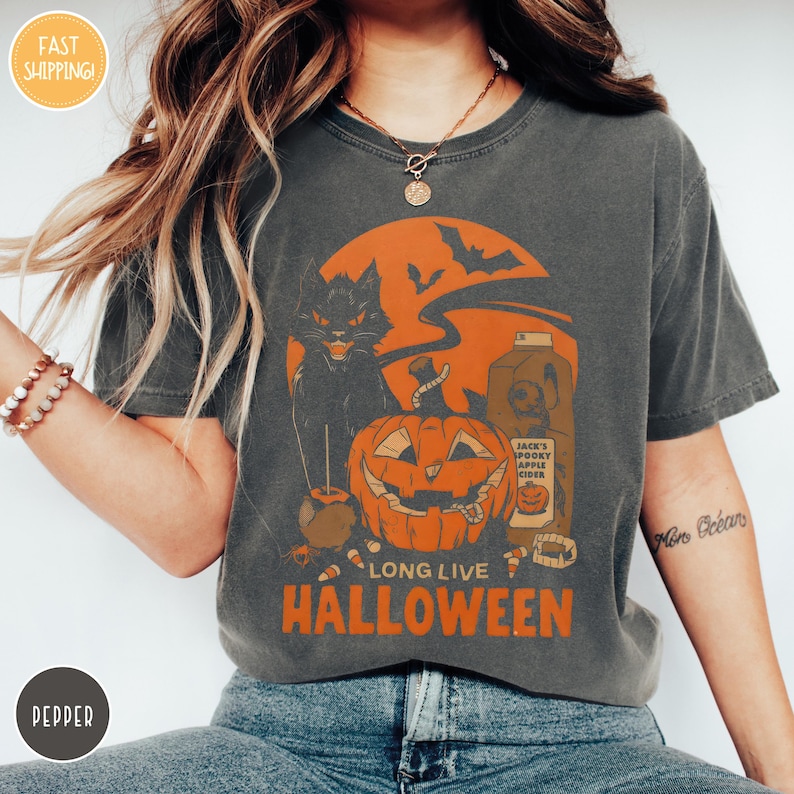 a woman wearing a long live halloween t - shirt