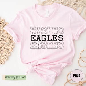 a pink shirt with the words eagles on it