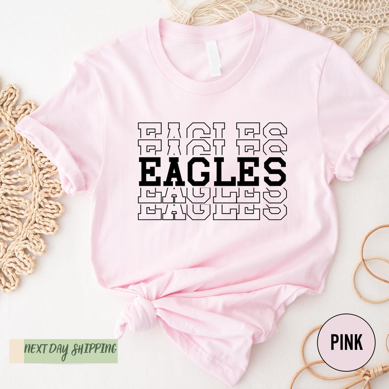 a pink shirt with the words eagles on it