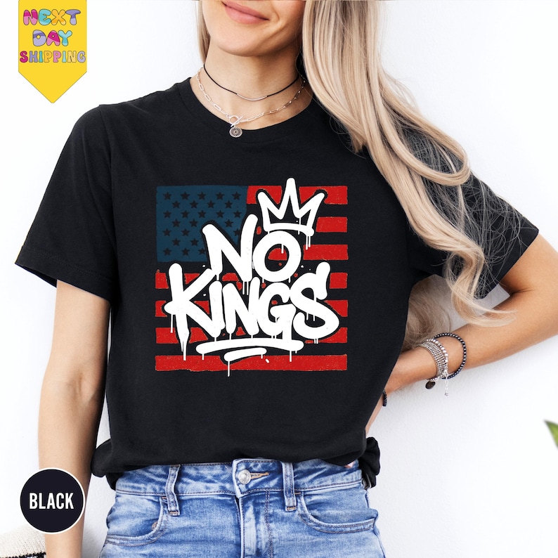 a woman wearing a black t - shirt with the words no kings on it