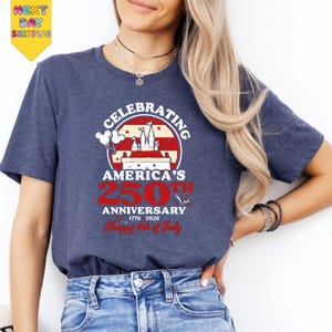 A woman wearing a blue t-shirt with a graphic design celebrating America's 250th anniversary.
