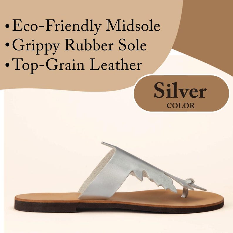 Infographic for handmade, top-grain, leather thong style sandal in metallic silver, with oak-leaf cutout design. Features natural hide colour, full-grain leather midsole. Callout 1 says -Eco-Friendly Midsole -Grippy Ruer Sole -Top-Grain Leather. Callout 2 says -Silver Color. Shown in a profile view of a single sandal. Photographed on a clean, white background.