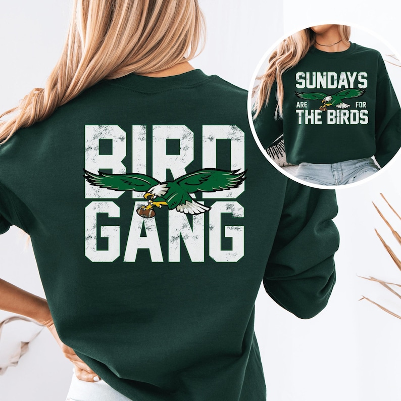 a woman wearing a green sweatshirt with the words bird gang on it