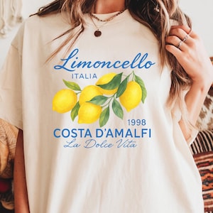 a woman wearing a t - shirt with lemons on it
