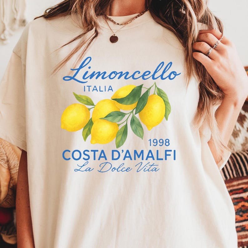 a woman wearing a t - shirt with lemons on it