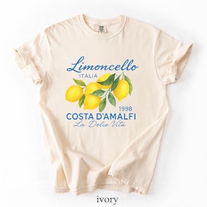 a white t - shirt with a picture of lemons on it