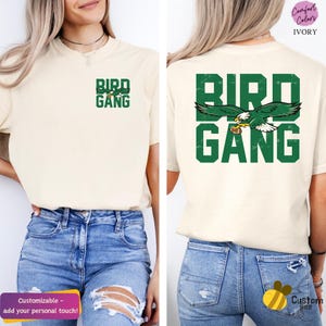 a woman wearing a bird gang t - shirt