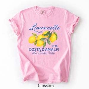 a pink t - shirt with lemons on it