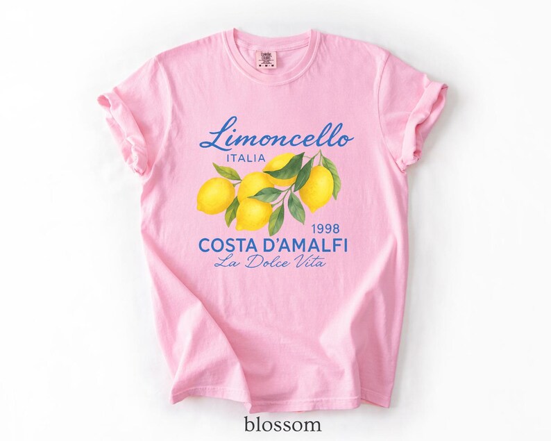 a pink t - shirt with lemons on it